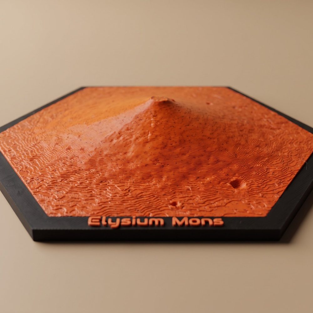 A hexagon Mars ornament of Elysium Mons: one broad volcano cone in orange-red on a black frame, with Elysium Mons in raised letters