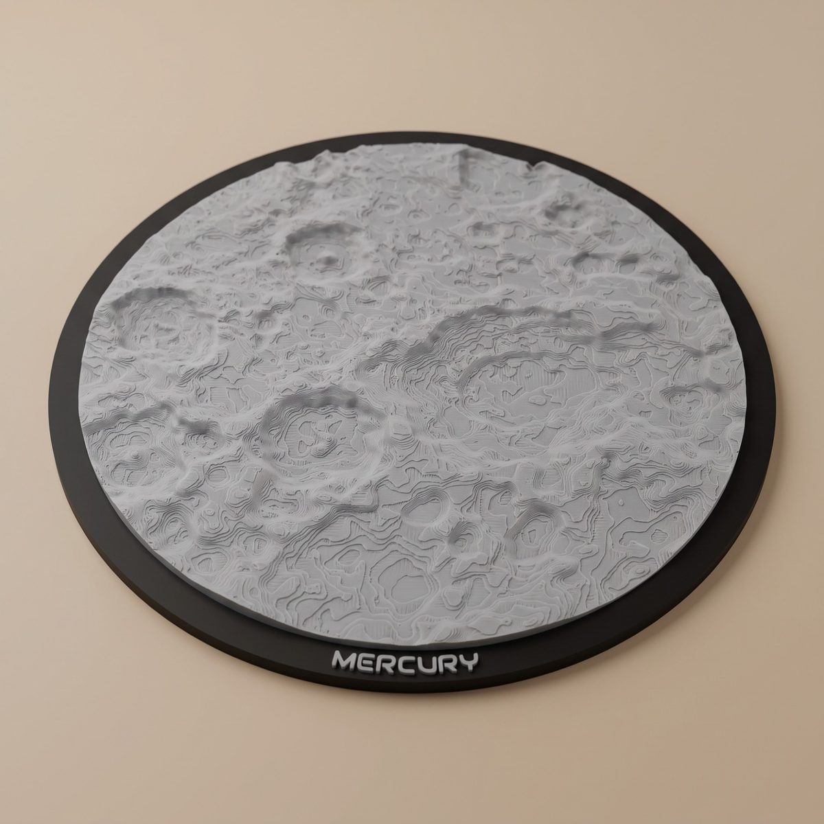 A round 3D-printed Mercury model in light grey on a black frame lettered MERCURY: impact craters with raised rims and central peaks, and the print's layers tracing the terrain like contour lines