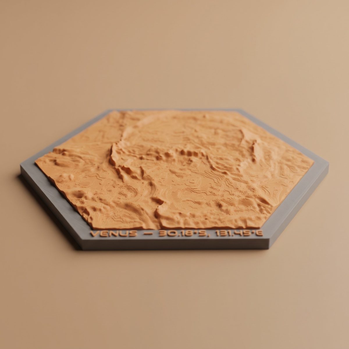 A photo of a printed hexagon Venus ornament in orange on a grey frame